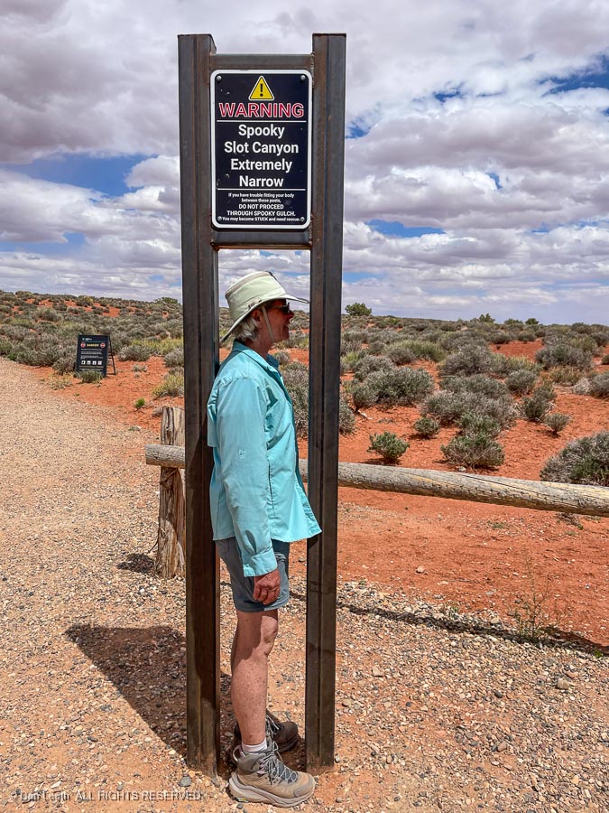 A person standing next to a sign

Description automatically generated with medium confidence